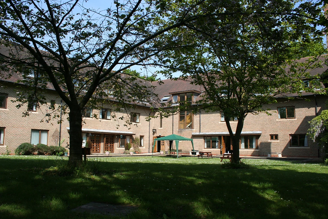 Back of the school building with benches