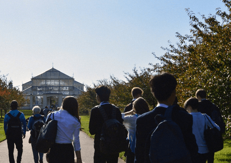 Pupils walk towards Temperate House at Kew Gardens