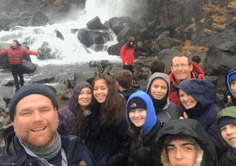 Group of pupils infront of waterfall in Iceland