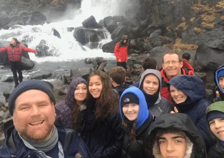 Group of pupils infront of waterfall in Iceland