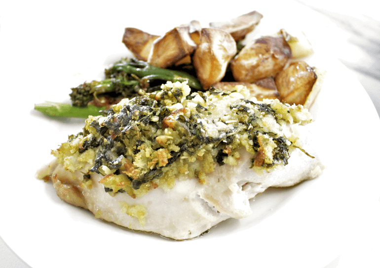 Dish of roast chicken breast with parmesan, basil and breadcrumb topping