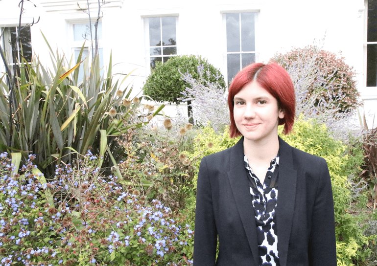 Leighton Park pupil Rowan Taylor in front of garden plants