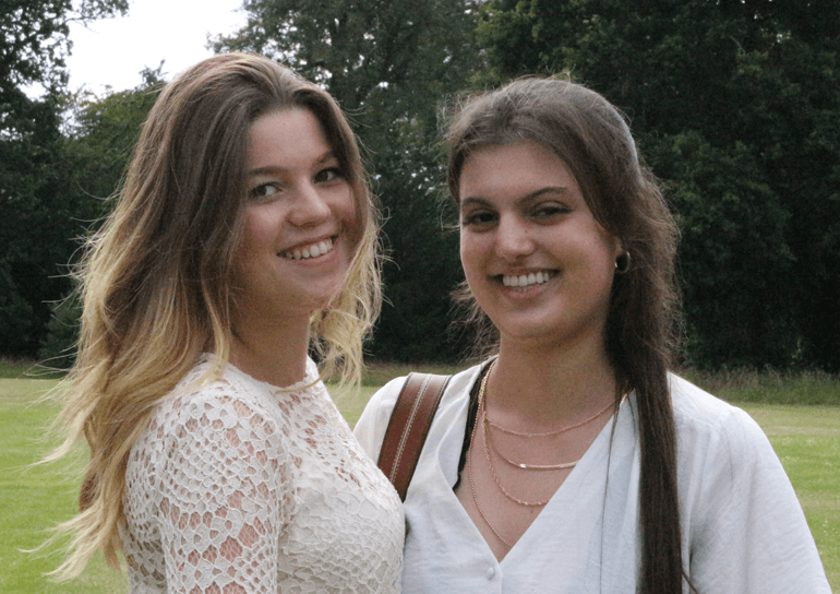 Two Leighton Park IB students smiling in School grounds