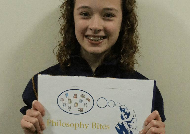 Leighton Park pupil holding up Philosophy Bites print out