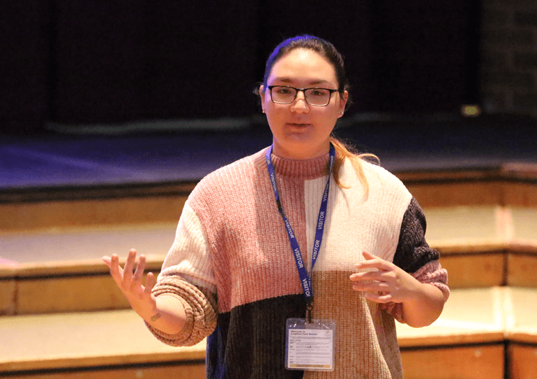 Lady speaking in an auditorium