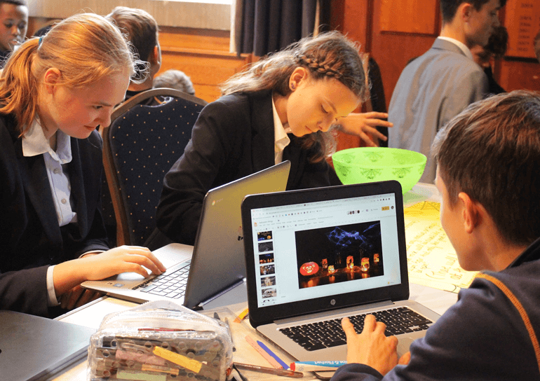Three Leighton Park students working on laptops
