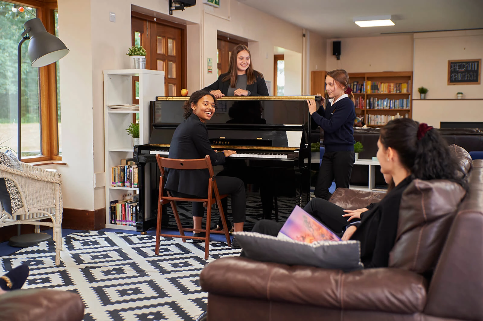 Girls chilling around piano
