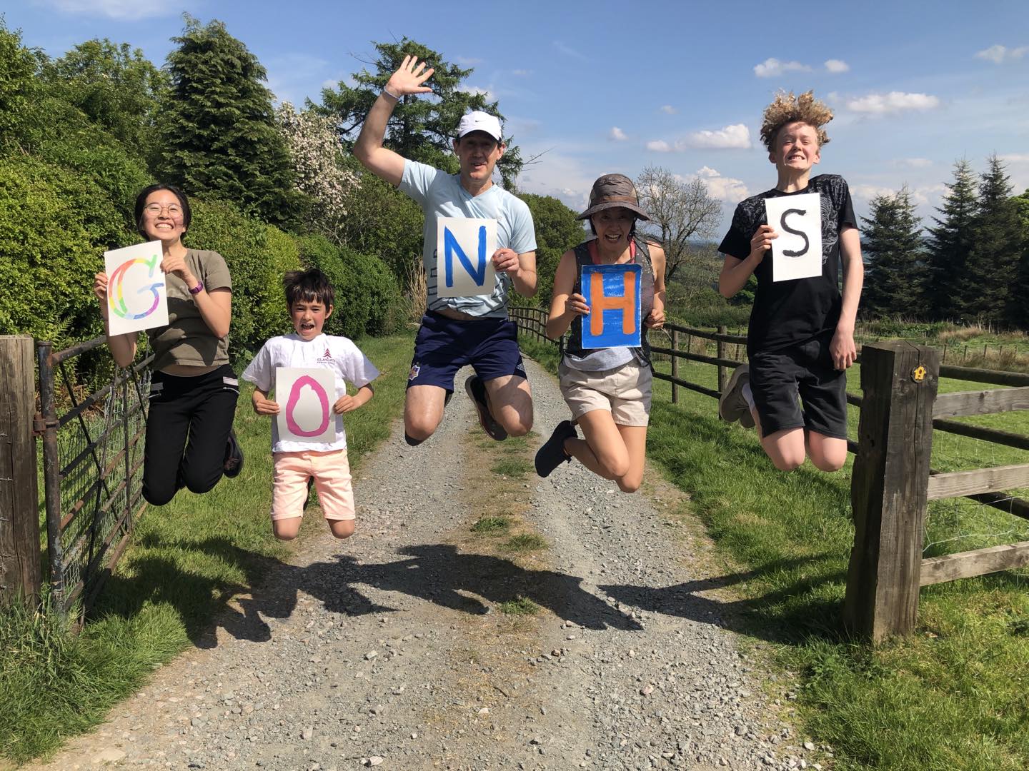 LP family jumping holding letters spelling Go NHS