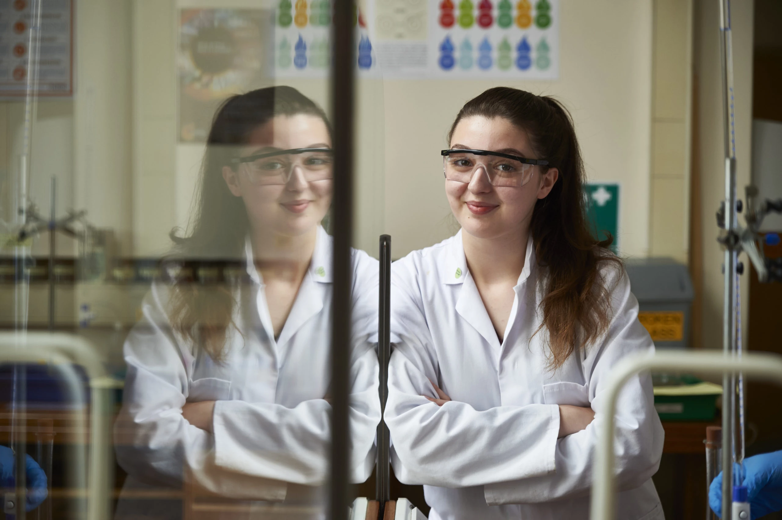 Adriana in lab coat and safety glasses