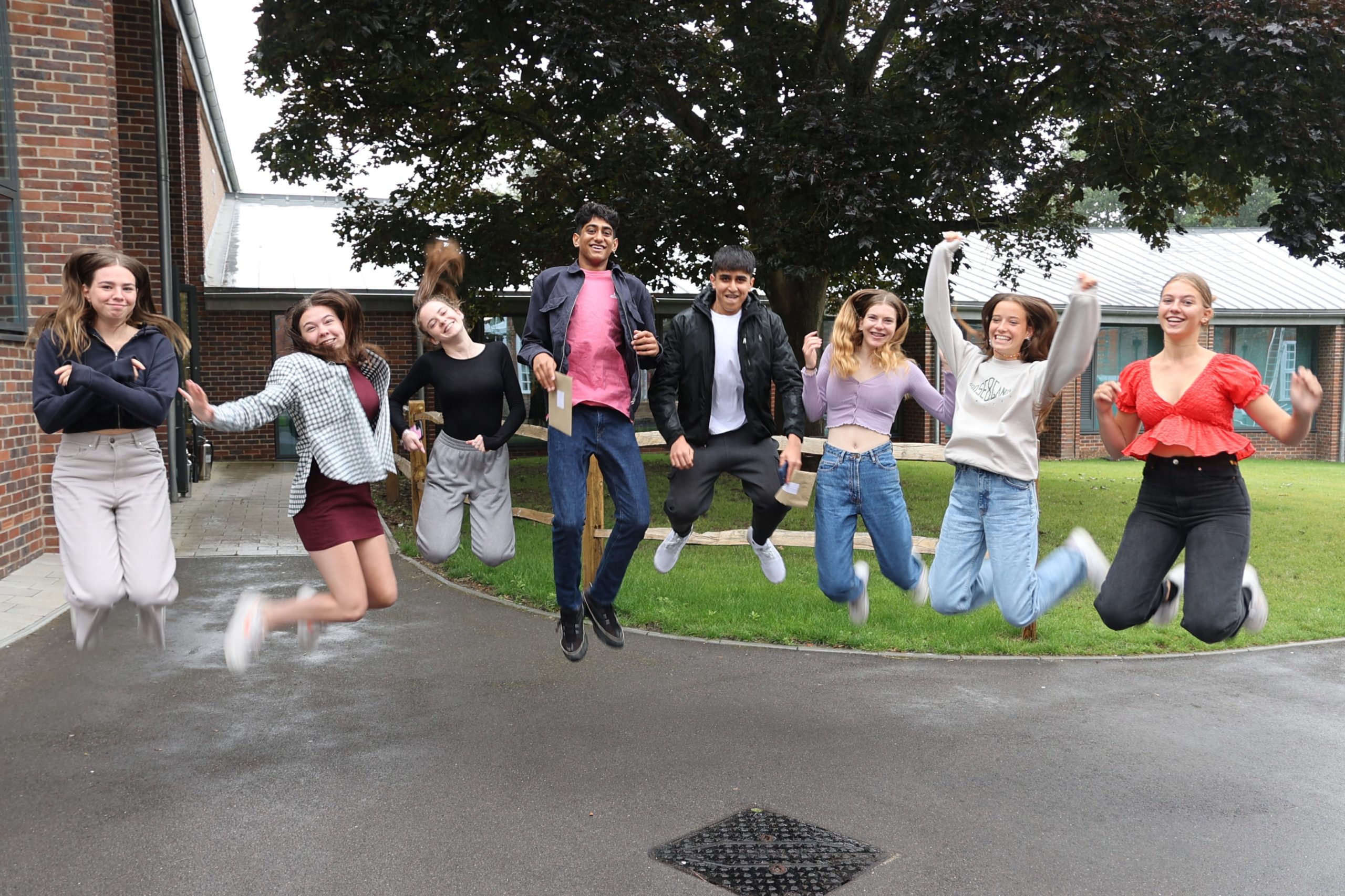 GCSE students jumping for joy after receiving results