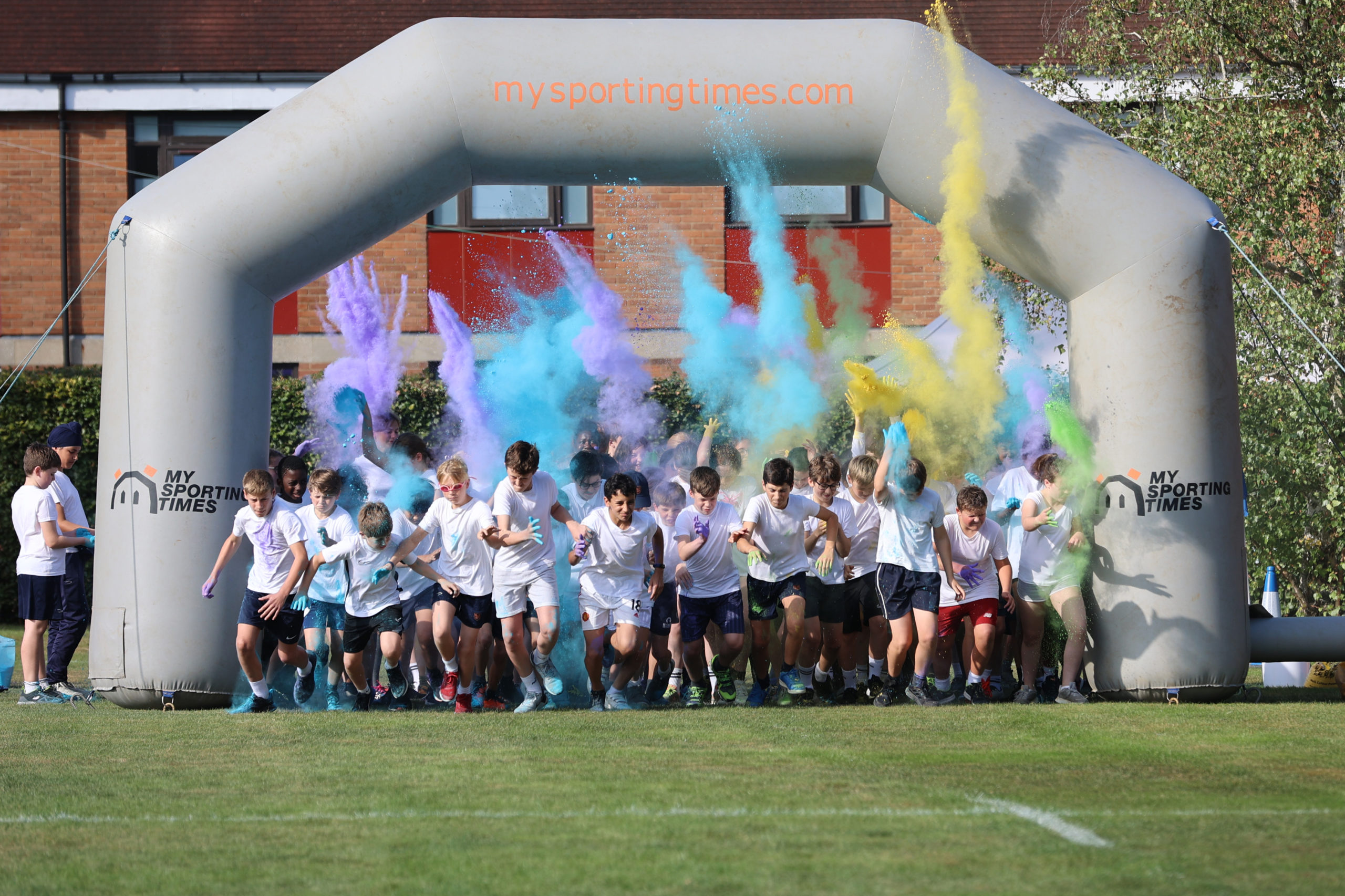 Race beginning, pupils running and colour bombs exploding