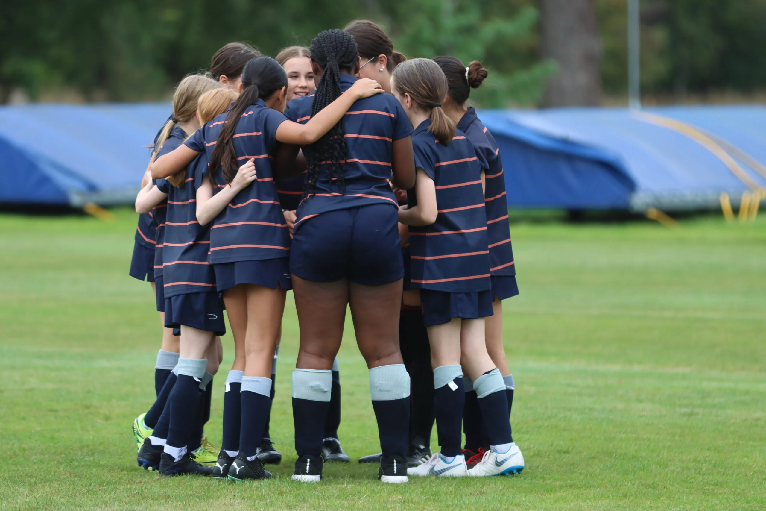 Huddle at girls' football match