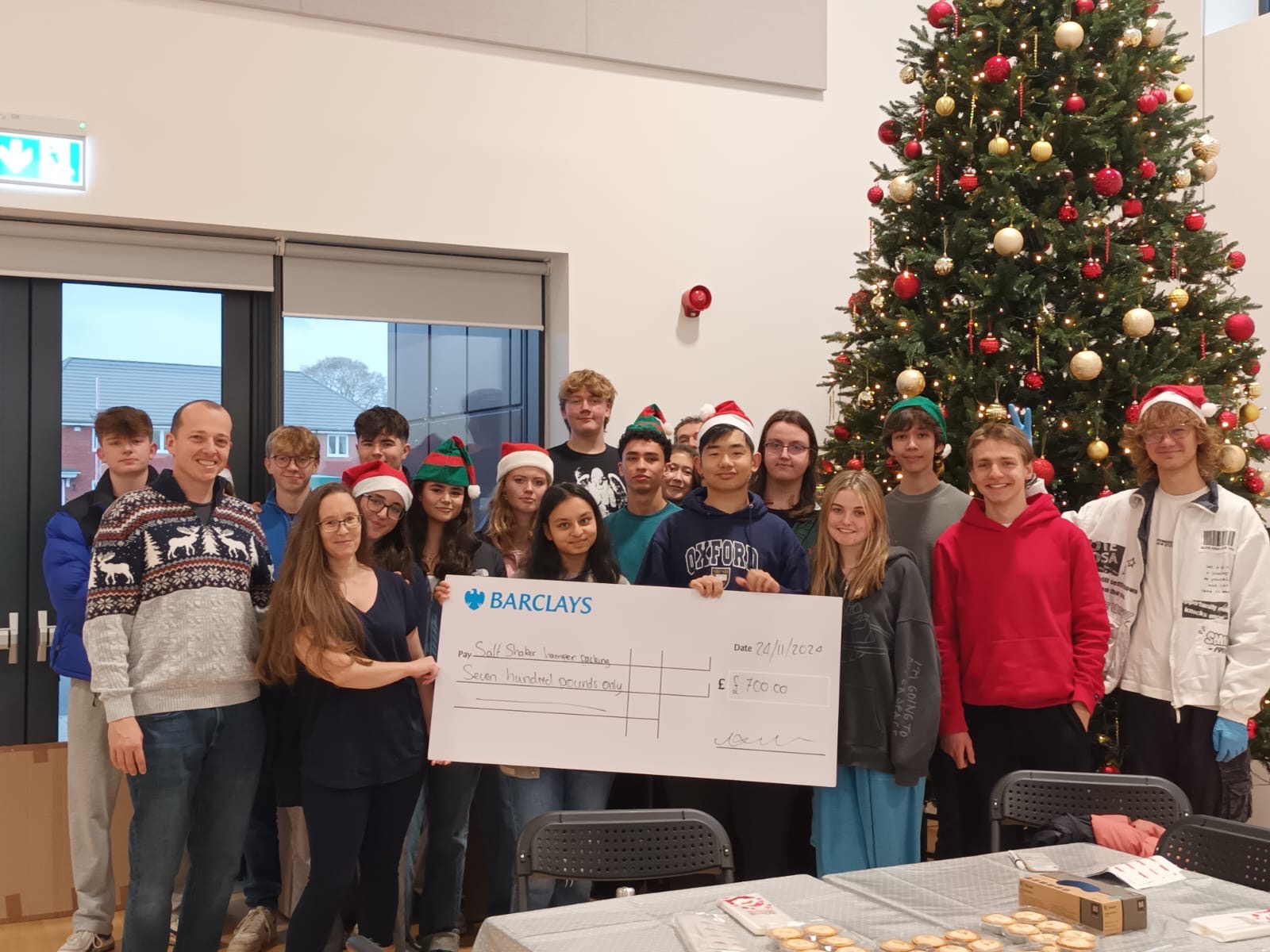 Social Enterprise presenting a £700 cheque to charity.